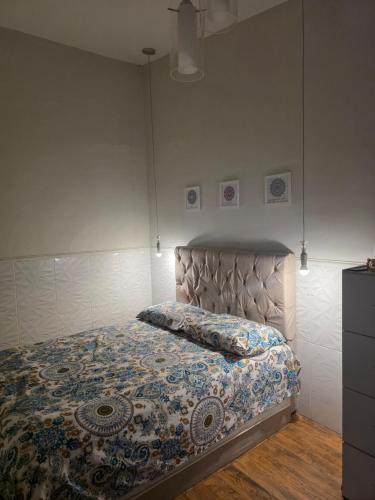 a bedroom with a bed with a quilt on it at Quarto Ametista in Aracaju
