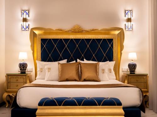 a bedroom with a large bed with a gold headboard at Solar Antigo Luxury Porto Aeroporto in Moreira