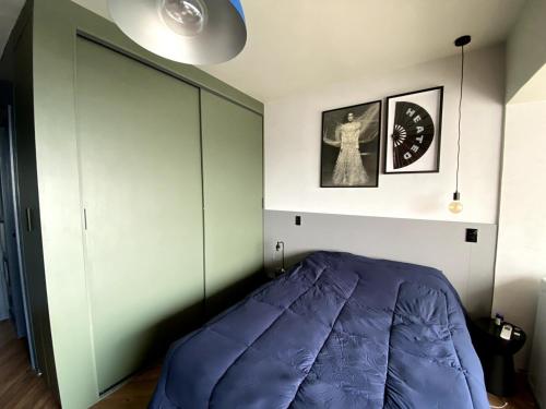 a bedroom with a large purple bed in it at Central Studio in the metro Butantã in São Paulo