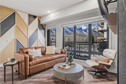 a living room with a couch and a table at New Luxury 3 bedroom in Canmore