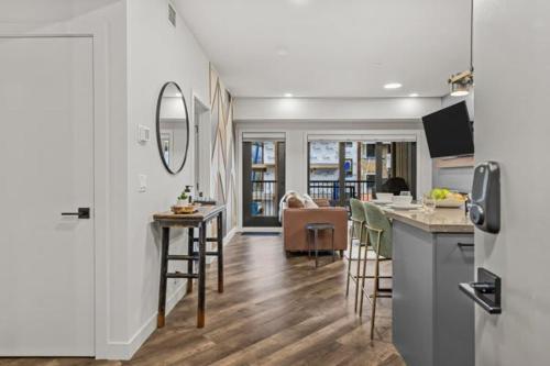 a kitchen and a living room with a table and chairs at New Luxury 3 bedroom in Canmore