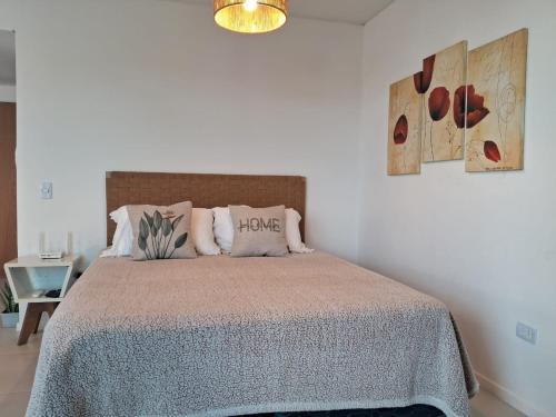 a bedroom with a bed in a white room at Metra DS Puerto Norte in Rosario