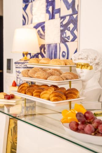 a display case with three tiers of pastries and fruit at Solar Antigo Luxury Porto Aeroporto in Moreira