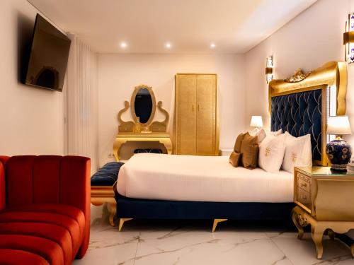 a bedroom with a large bed and a red couch at Solar Antigo Luxury Porto Aeroporto in Moreira