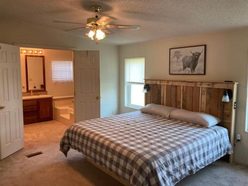 a bedroom with a bed and a sink and a bathroom at High Plains Hideout 3 bedrooms 2 Baths in WaKeeney