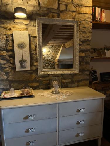 a dresser with a mirror on top of it at B&B Casa Lupi in Ronchi