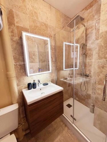 a bathroom with a sink and a shower at Charming Getaway Near Paris in Alfortville