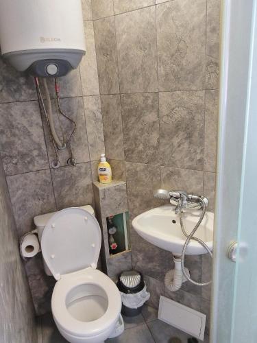 a small bathroom with a toilet and a sink at City Centre Suits 3 in Varna City