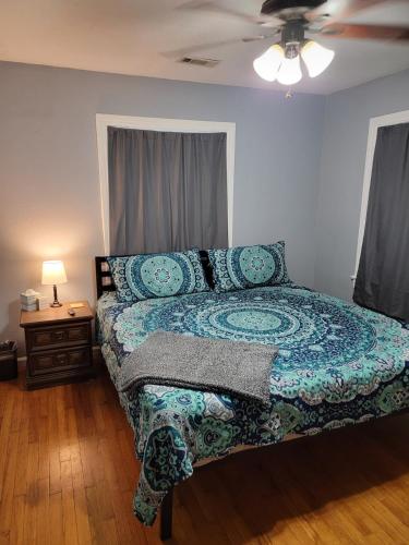 a bedroom with a bed and a ceiling fan at 5 minutes from Garrison Ave in Fort Smith