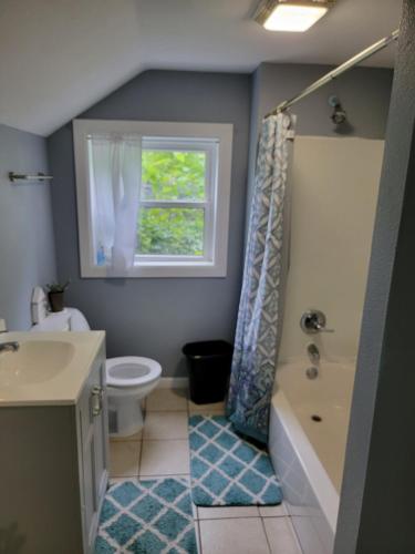 a bathroom with a sink toilet and a window at 5 minutes from Garrison Ave in Fort Smith