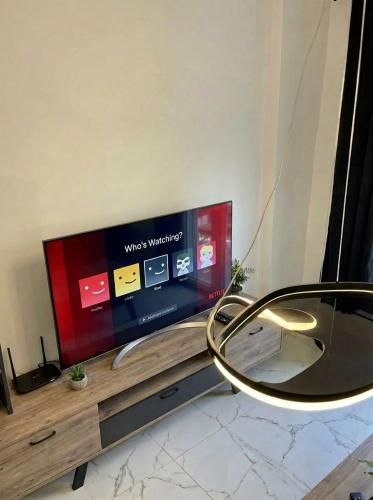 a tv sitting on top of a wooden table at White Port Suite in Ágios Rókkos