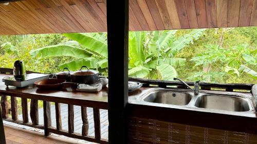 a kitchen counter with a sink and a window at Lam Mountain Retreat Ông Lang in Phú Quốc