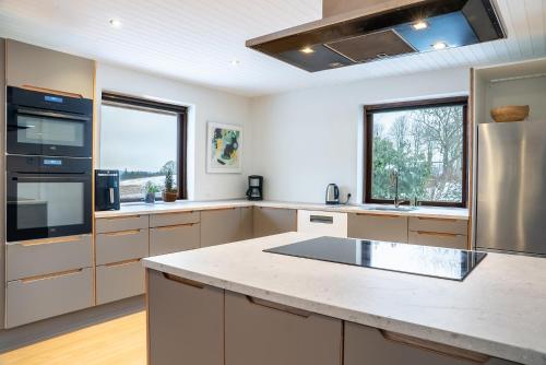 a kitchen with a large island in a kitchen at Country View Village House near Lake 6 persons in Østbirk