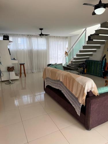a bedroom with a bed and a staircase at Casa em Condomínio in Bertioga
