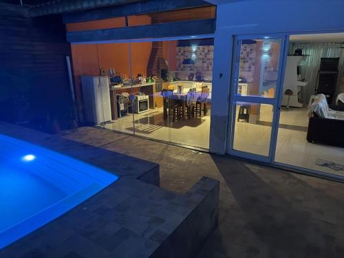 a house with a swimming pool and a dining room at Casa em Condomínio in Bertioga
