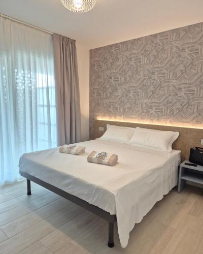 a bedroom with a bed with two towels on it at Libra Aparthotel in Bibione