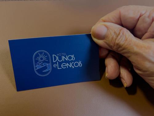 a hand holding a blue card that reads not the duds laws at Hotel Dunas e Lençóis in Barreirinhas