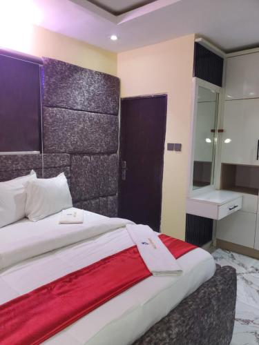 a bedroom with a large bed with a red blanket at Vingoze Apartments in Fatade