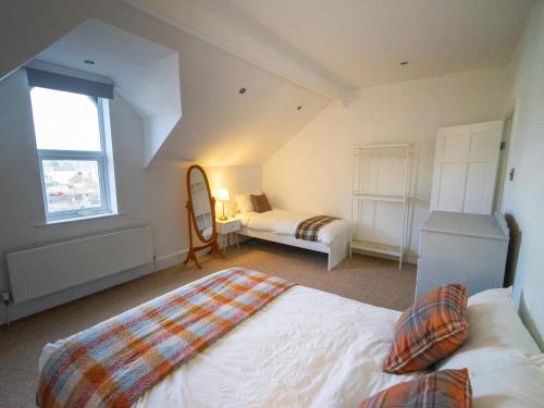 a bedroom with a bed and a mirror in a room at The Red Door in Bangor