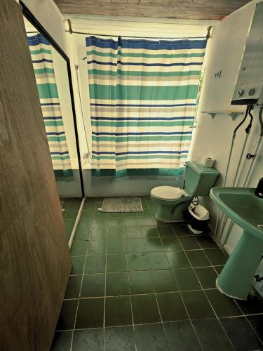 a bathroom with a toilet and a sink at Paioneal Hostel l Spa Jacuzzi Sauna in El Quisco