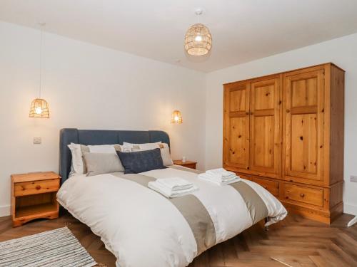 a bedroom with a large bed and a wooden cabinet at Shamrock in Exeter