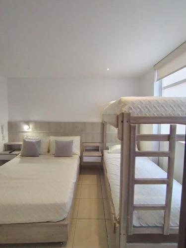 a room with two bunk beds and a ladder at HOTEL GRAND BOUTIQUE in Fusagasuga