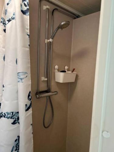 a shower with a shower head in a bathroom at Ulvsby Ranch Western Camp in Karlstad