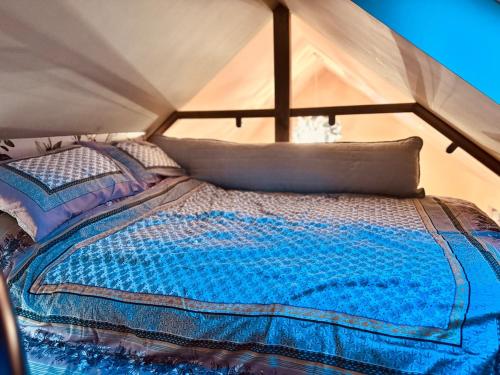 a bedroom with a bed in a tent at Golden Oak Guest House in North Leigh