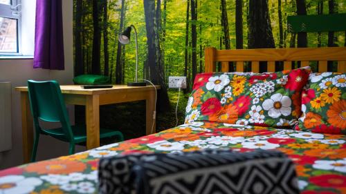 a bedroom with a bed and a desk with a table at Igloo Hybrid in Nottingham