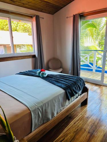 a bedroom with a bed and a large window at Blue Marlin in Bocas Town
