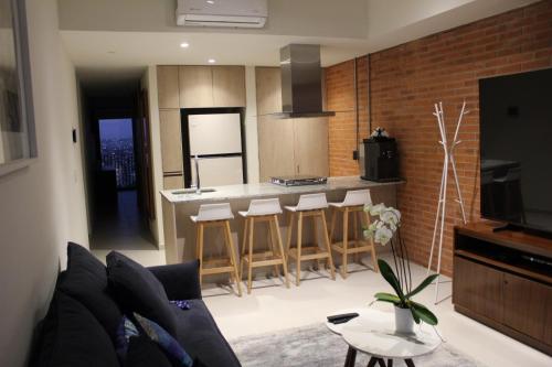 a living room with a couch and a kitchen at New apartment in Yu Country GDL view 22nd floor in Guadalajara