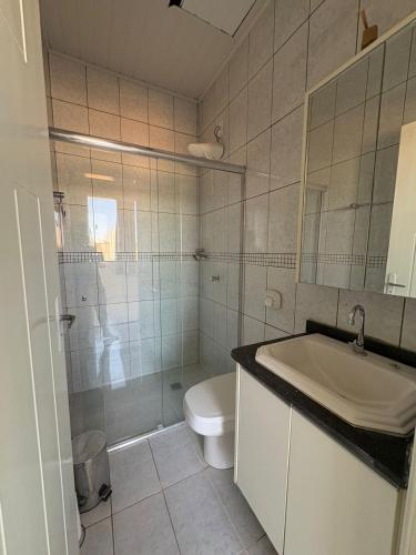 a bathroom with a sink and a toilet and a shower at Loft J&C 01 in Primavera do Leste