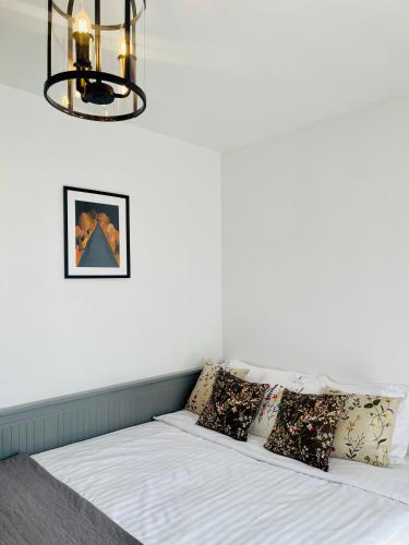 a bedroom with a bed with pillows and a chandelier at Casa Cara in Târgovişte