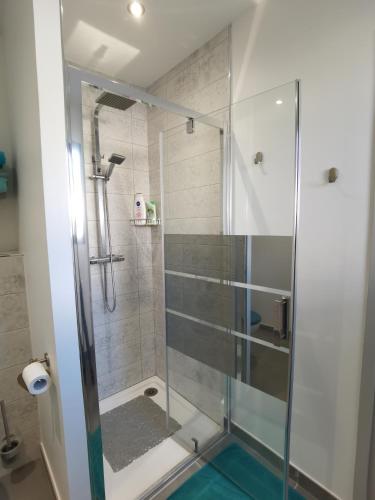 a bathroom with a shower with a glass door at Chambre d'hôte " Ô Soleil " in Vaison-la-Romaine