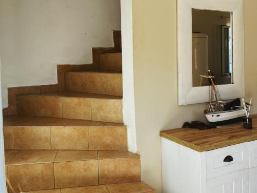a staircase in a room with a mirror and a mirror at Sea View Villa Irene - Private Pool and Sunset Terrace in Evretí
