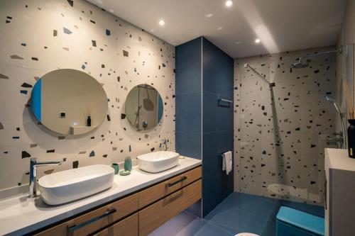 a bathroom with two sinks and a shower at Luxury Seafront Villa Aman Korcula with Pool in Korčula