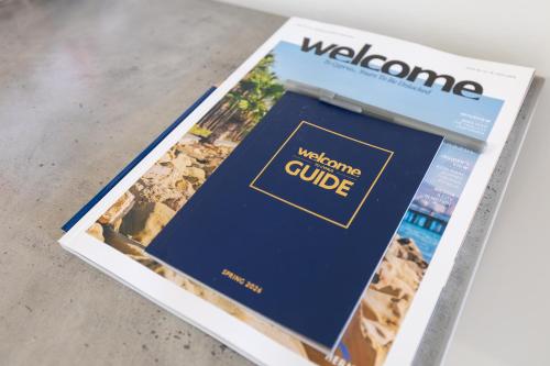 a magazine sitting on top of a table at Casa Sol - Bright 3BR Steps from the Beach & Shops in Limassol