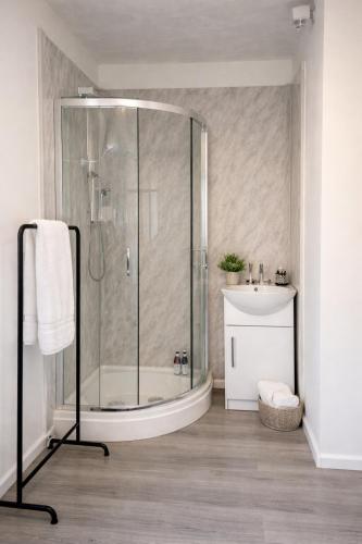 a bathroom with a shower and a sink at Large 4 bedroom house for Contractors, Large groups or Retreat sleeps 8 people in Durham - NO Smoking Indoor House in Edmondsley