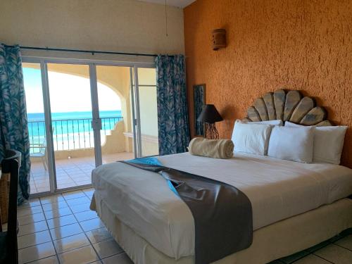 a bedroom with a bed with a view of the ocean at Las Gaviotas Condo-Hotel La Paz BCS in La Paz