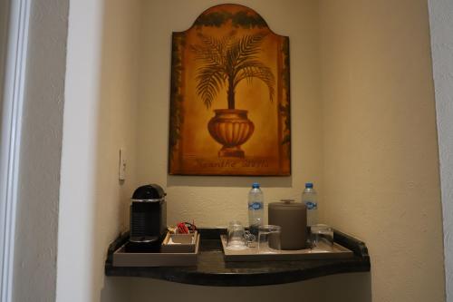 a bathroom with a shelf with a coffee maker on it at Pierre Mundo Imperial Riviera Diamante Acapulco All Inclusive in Acapulco