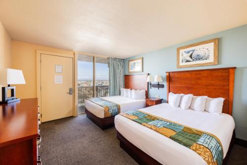 a hotel room with two beds and a window at Reges Oceanfront Resort in Wildwood Crest