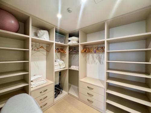 a walk in closet with white cabinets and shelves at Casa La Perla in Budva