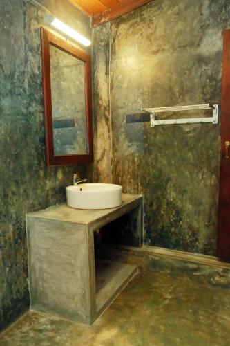 a bathroom with a sink and a mirror at Muraaya in Habaraduwa Central