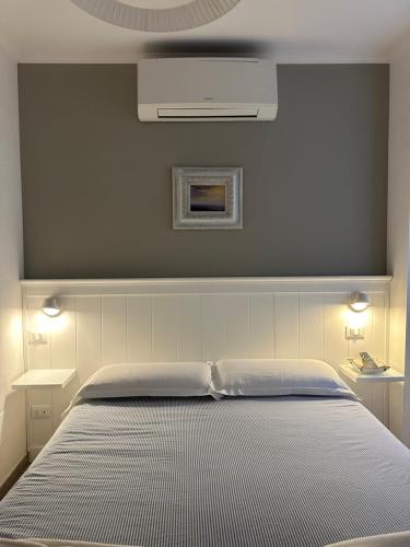a bedroom with a white bed with two tables at La Linea D'Acqua in Manarola