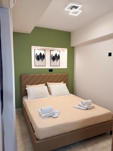a bedroom with a bed with two towels on it at Thalori Home Georgioupolis in Georgioupolis