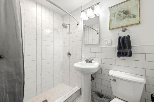 a white bathroom with a sink and a toilet at Atlanta North Urban Chic 2BR- 7th Floor in Atlanta