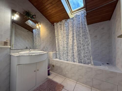 a bathroom with a tub and a sink and a shower at Aguerrea in Macaye