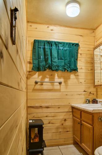 a wooden bathroom with a sink and a stove at Milner Pass Cabin Retreat in South Fork
