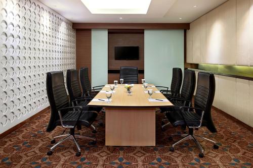 a conference room with a large table and chairs at Aston Solo Hotel in Solo