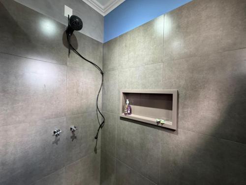a bathroom with a shower with a shower head at Suite Juede Platz - 02 - Centro de Pomerode in Pomerode